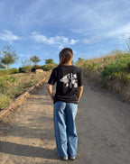 Black graphic logo T-shirt, crew neck, short sleeves; back print visible.