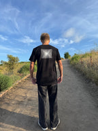 Black crew-neck tee with back square geometric logo patch