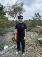 Black crew-neck T-shirt with small chest logo patch