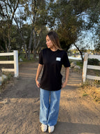 Black crew-neck tee with small square geometric logo on chest