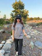 Black baseball cap with small front logo patch and curved brim