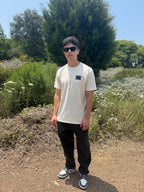 Bone crew-neck tee with small square geometric logo on chest